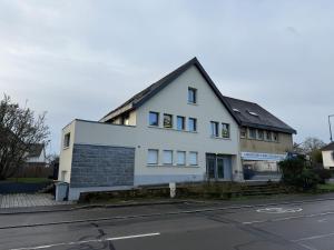 ein weißes Gebäude am Straßenrand in der Unterkunft T2 neuf marbre et or - écran géant - Netflix in LʼHermitage