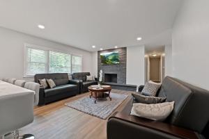 a living room with a couch and a fireplace at Exceptional Willowbrook Retreat in Willowbrook