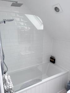 a white bath tub in a white bathroom at Modern Flat Near Dover Castle in Dover