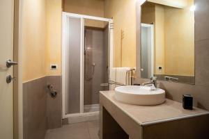 a bathroom with a sink and a shower at Piacenza centro in Piacenza