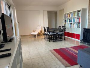 a living room with a table and chairs and a television at La Casa dell'Aviatore in Boccadifalco