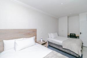 Ένα ή περισσότερα κρεβάτια σε δωμάτιο στο Peace Haven Sandton +18 φωτογραφίες