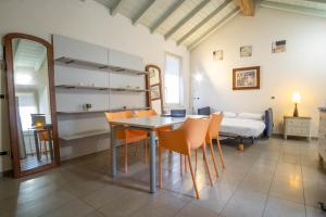 a dining room with a table and chairs and a bed at Piacenza centro in Piacenza +16 photos