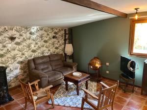 a living room with a couch and a table at Gite Deja Vu in Montcabrier