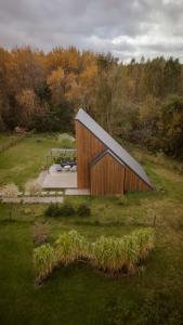 a small wooden building in a field with trees at Zen Sasino in Sasino