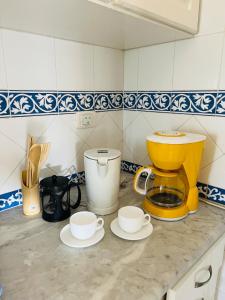 a kitchen counter with two cups and a mixer at Maison Douceur in Dar el Ouzir +14 photos
