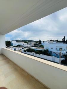 a balcony with a view of a city at Maison Douceur in Dar el Ouzir