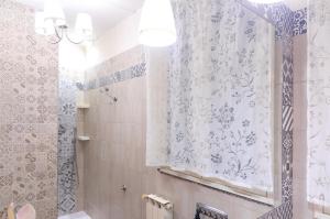 a bathroom with a shower and a shower curtain at Casa delle Zammare Fronte mare centro storico in Riposto +37 photos