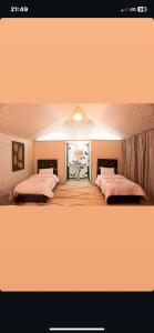 a room with two beds and a window in it at Agafay dreams in Marrakech