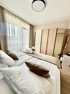 a bedroom with two beds with pillows on them at Sorrento E 4 4 Sveti Vlas in Sveti Vlas