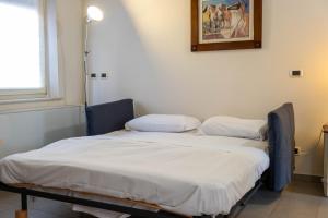 two beds in a room with a picture on the wall at Piacenza centro in Piacenza