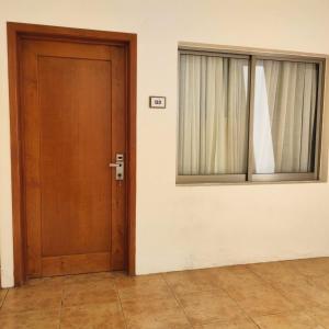 a wooden door and a window in a room at Hotel Azul Agave Oaxaca in Yelateni