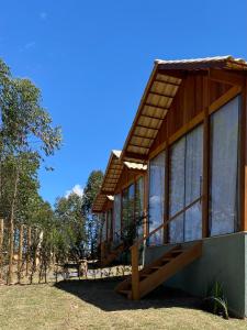 a small house with a porch and windows at Chalé Colibri Verde in Santa Teresa