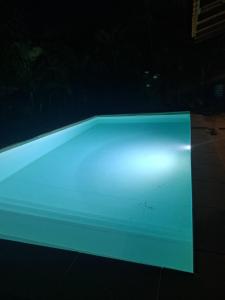 a swimming pool lit up at night at Studio Kerbignon, Piscine privée in Case-Pilote
