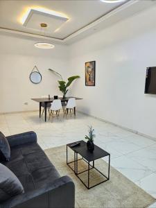 a living room with a couch and a table at Résidence Jordan in Dakar +2 photos