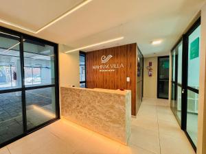 a lobby of a building with a sign on the wall at Mahrak Villa - VSH in Porto De Galinhas +78 photos