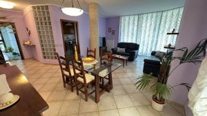 a living room with a glass table and chairs at Salseadine - Senigallia in Marzocca di Senigallia