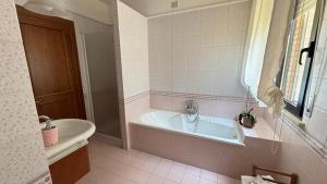 a bathroom with a bath tub and a sink at Salseadine - Senigallia in Marzocca di Senigallia