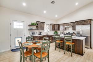 a kitchen with a table and chairs and a kitchen with a refrigerator at Hike and Ski! Home with Dog-Friendly Yard in Eagar in Eagar