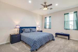 a bedroom with a blue bed and two windows at Hike and Ski! Home with Dog-Friendly Yard in Eagar in Eagar
