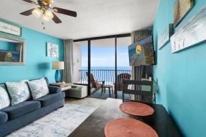 a living room with a couch and a view of the ocean at Palms Resort 905- Oceanfront in Myrtle Beach
