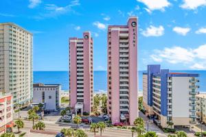a group of tall buildings with the ocean in the background at Palms Resort 905- Oceanfront in Myrtle Beach