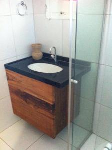 a bathroom with a sink and a glass shower at Pousada Brisa Do Pontal in Fortim +12 photos
