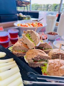 a group of sandwiches on a table with other foods at Hotel Ibis Tatui in Tatuí