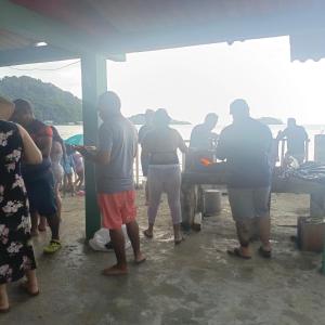 a group of people standing in front of a truck at Nilka sunset house in Colón