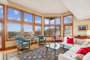 a living room with a lot of windows at Valley View in Stowe
