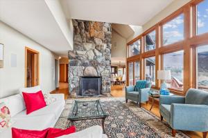 a living room with a stone fireplace at Valley View in Stowe