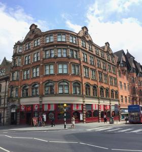 a large brick building on the corner of a street at Comfortable Studio in City Centre Nottingham in Nottingham