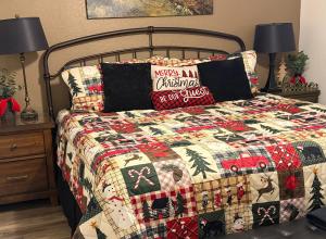 a bedroom with a bed with a christmas quilt at A Beary Good Getaway condo in Pigeon Forge