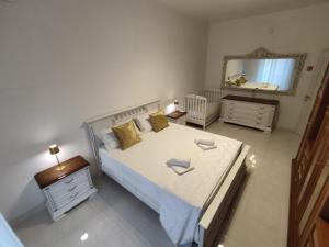 a bedroom with a large bed and a mirror at HOME SWEET HOME Casa vacanze e affitti brevi in Trani