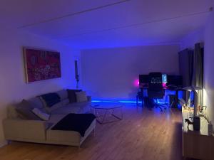 a living room with a couch and a table at Lejlighed in Måløv