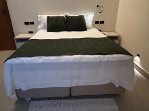 a bedroom with a large bed with two night stands at Loft Jeri Premium in Jericoacoara