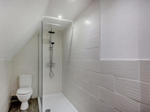 a white bathroom with a toilet and a shower at 4 Bed in Beaumaris 94501 in Llanddona +33 photos