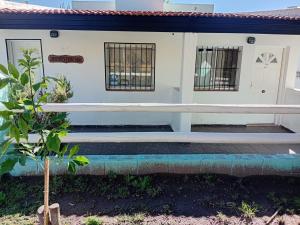 a house with a bench in front of it at Cabañas Yaqui in Potrero de los Funes