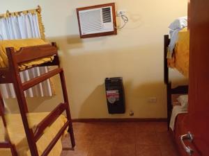 a room with a dorm room with a fan at Cabañas Yaqui in Potrero de los Funes