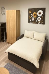 a bedroom with a bed and a wooden cabinet at Twenty2 Apartments in Brühl