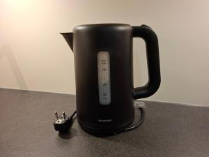 a black coffee maker with a remote control in it at Stuttgart City Apartment B in Stuttgart