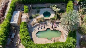 an overhead view of a swimming pool with a resort at Mountain Camp Ali Khaled in Siwa