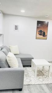 a living room with a couch and a table at Ivey Homes in Edmonton +15 photos