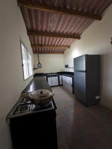 a kitchen with a stove and a refrigerator at Nilka sunset house in Colón +10 photos