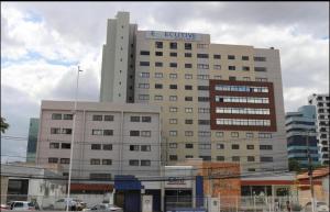 a large building with a sign on top of it at Apart estiloso! in Feira de Santana