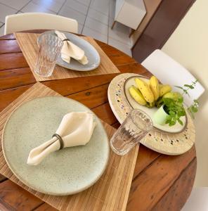 a wooden table with plates of food on it at Loft Central Orgânico in Passos +29 photos