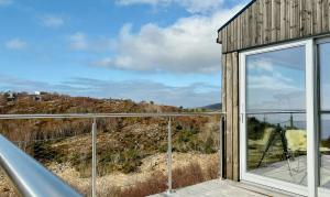 a glass house with a view at Architect Drawn Cabin With Sea View At Stokkøy in Hosen