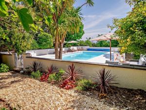 a swimming pool in a yard with a fence at 2 Bed in Minehead 90925 in Minehead +25 photos