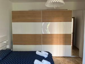 a bedroom with a bed with two towels on it at Pretty Favetti - lovely apartment in Trieste with a sea view - in Trieste