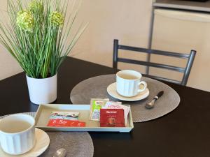 a table with two cups of coffee and a tray at G6 Monoambiente King con Cochera en Villa Ángela in Villa Ángela